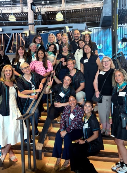 Varicent team members posing together on a staircase at a company event